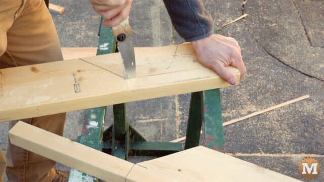 firewood cutting jig - pocket hand saw handles on sawhorse