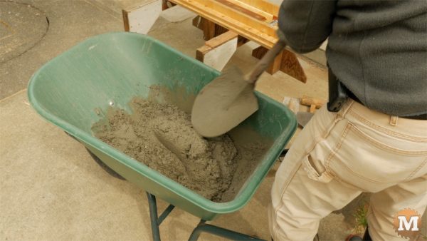 Mix concrete with cold water in wheelbarrow