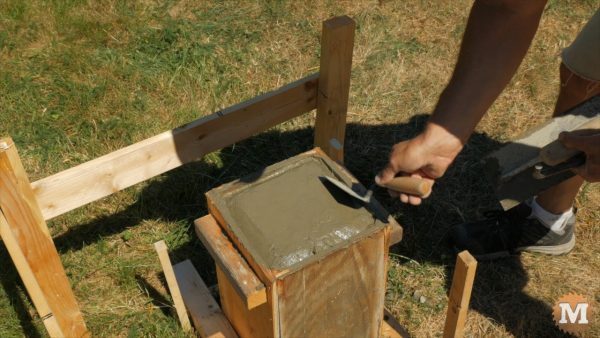 A chamfer on the top edge is formed by hand with small trowel - Finishing Concrete