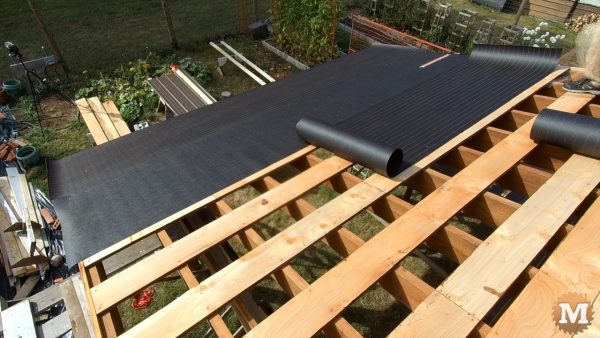Overlapping tar paper and stapling to strapping, Post and Beam Gazebo