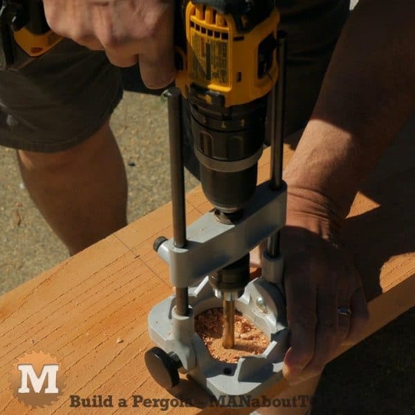 using a drill guide on the cedar pergola main beams