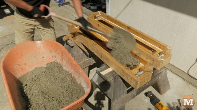 Shovelling Lavarock concrete into a form