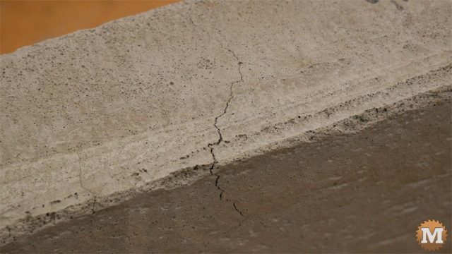 Cracks formed along the upper inside edge of the panels as a result of the bowing