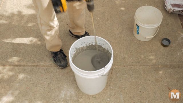 mixing the concrete in a pail