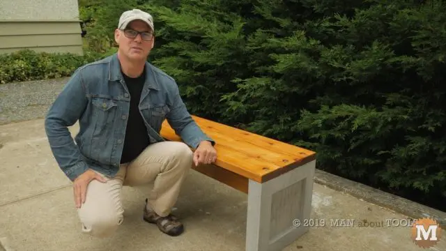 the author and the outdoor concrete garden bench