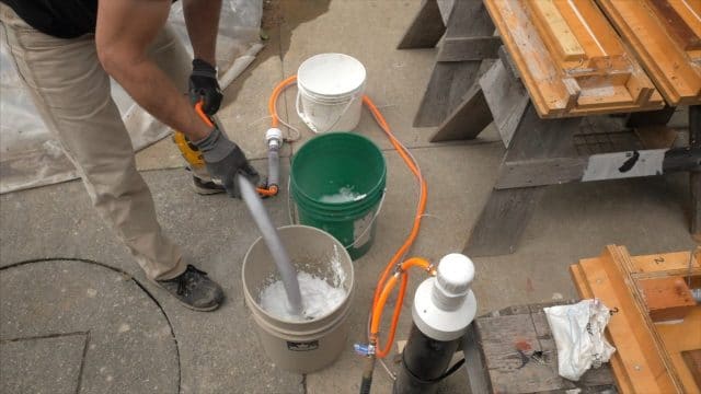 adding foam to the pail of wet cement aircrete CSA mix