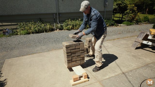 loading the concrete panel with a stack of bricks