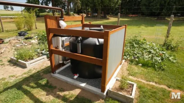 This off-grid 500 gallon tank is situated in the garden and feeds a small irrigation system that is powered by a 12V pump.