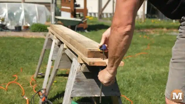 Clamping rough milled deck boards to sawhorse jig