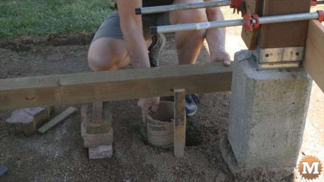 Adding concrete tubes to holes for deck footings