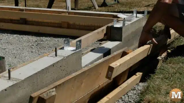 Stripping forms from a concrete foundation