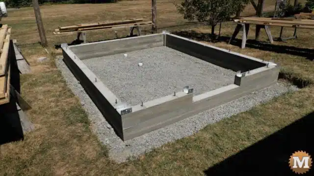 A poured concrete foundation for a post and beam greenhouse