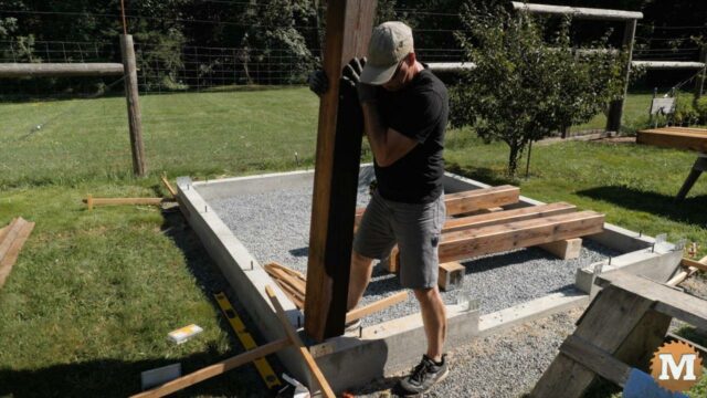 Setting a corner post into a galvanized saddle for a greenhouse