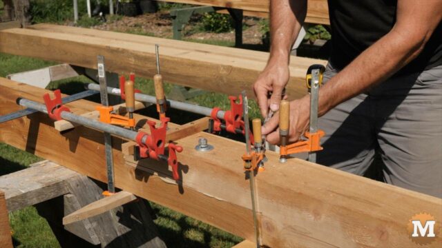 Assembling the scarf joint in a 6x6 cedar timber with bolts and clamps