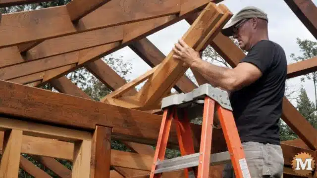 Removing a temporary ridge beam support from a cross tie beam