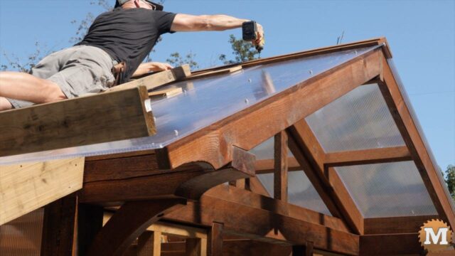 Installing a metal ridge cap to greenhouse roof