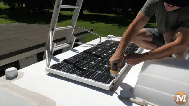 Removing the existing stock solar panel from the roof of the truck camper