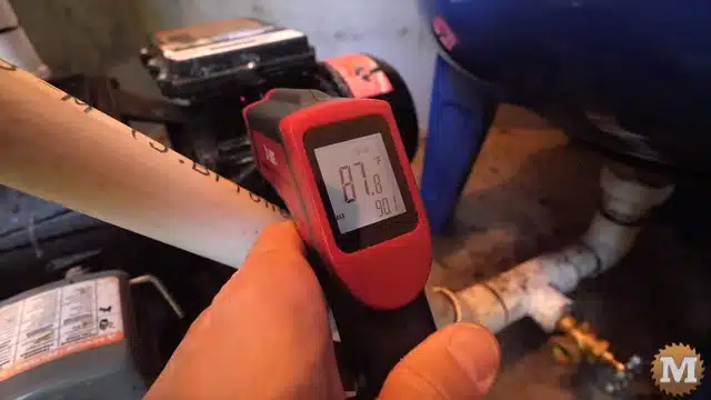 Checking the temperature of the running pump motor after 10 minutes of watering gardens