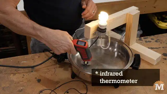 Checking pan temperature with infrared thermometer