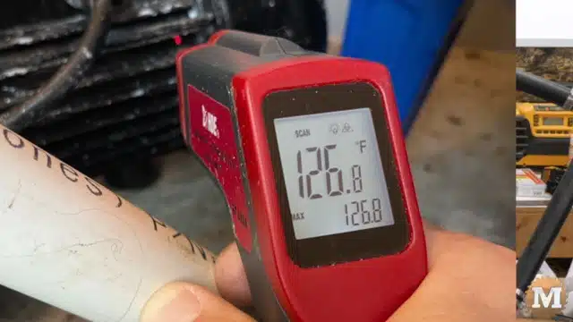 Infrared Thermometer checking the temperature of the jet pump motor under load
