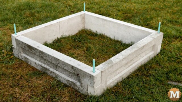 a three foot by three fot raised concrete garden bed pinned together at the corners with epoxy coated rebar