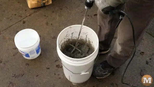 mixing concrete in a pail with a high torque drill and mixing attachment