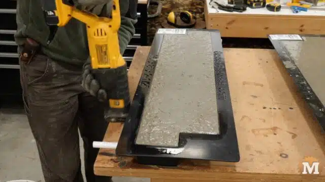 a reciprocating saw (without the blade) is used to vibrate the table and settle the concrete