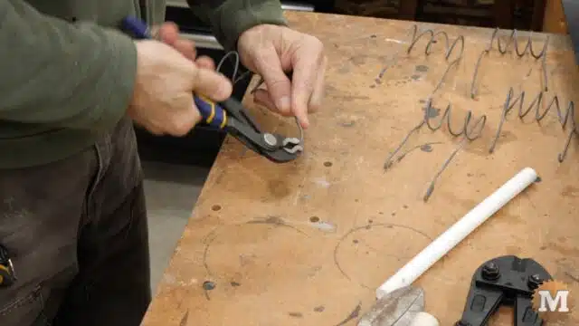bending the ends of the sharp cut fence wire