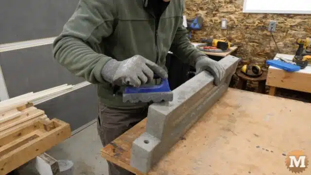 a rub brick with a plastic handle is used to smooth the sharp edges of the concrete casting