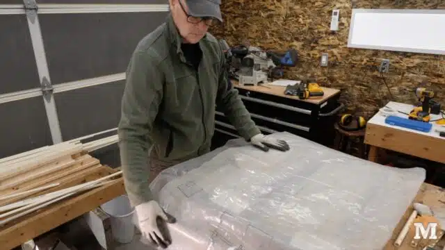 covering the concrete with sheets of plastic to slow drying