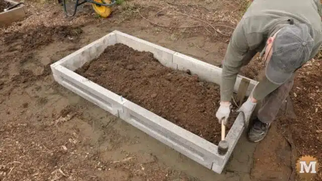 tapping the rebar into the ground with a rubber mallet
