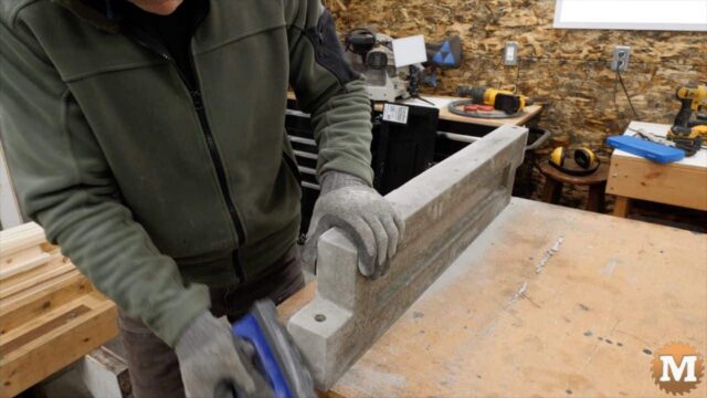 using a rub brick took to smooth edges of poured concrete panel