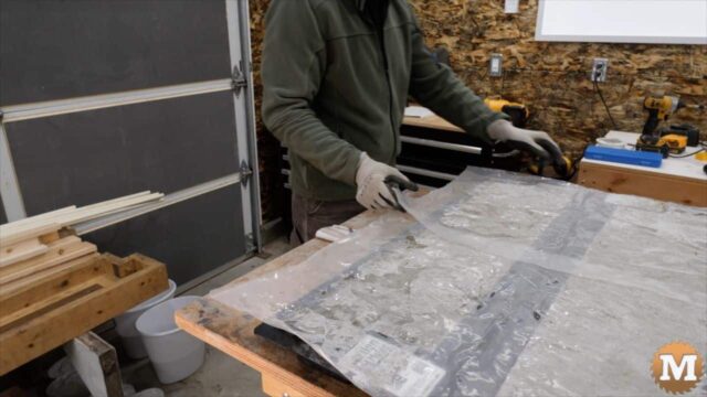 covering the concrete with plastic sheets to hold in moisture and warmth